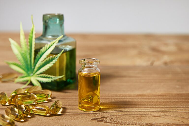 Medicinal cannabis with extract oil in a bottle on wooden background, Healthcare concept, Empty spac